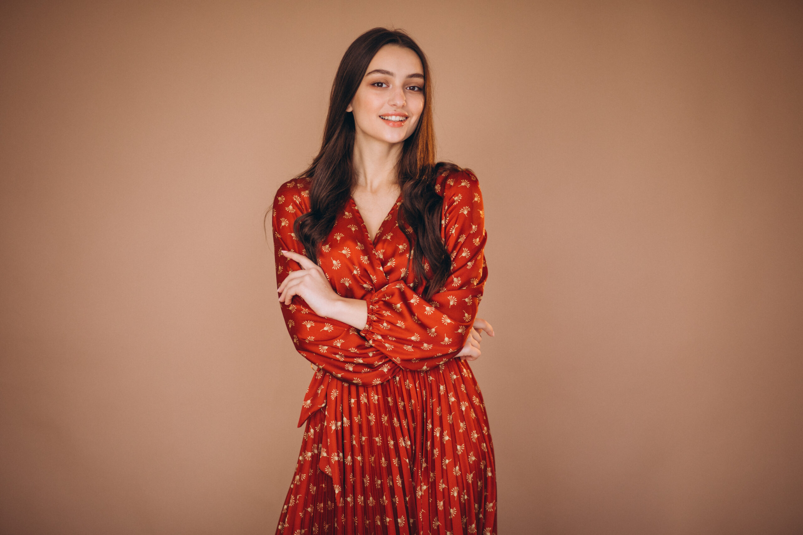 Young woman in a beautiful red dress in studio